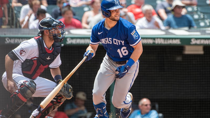 Kansas City Royals' Andrew Benintendi watches his hit with Cleveland Guardians catcher Luke...