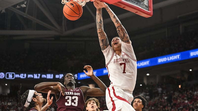Arkansas forward Trevon Brazile (7) dunks the ball over Texas A&M forward Federiko Federiko...