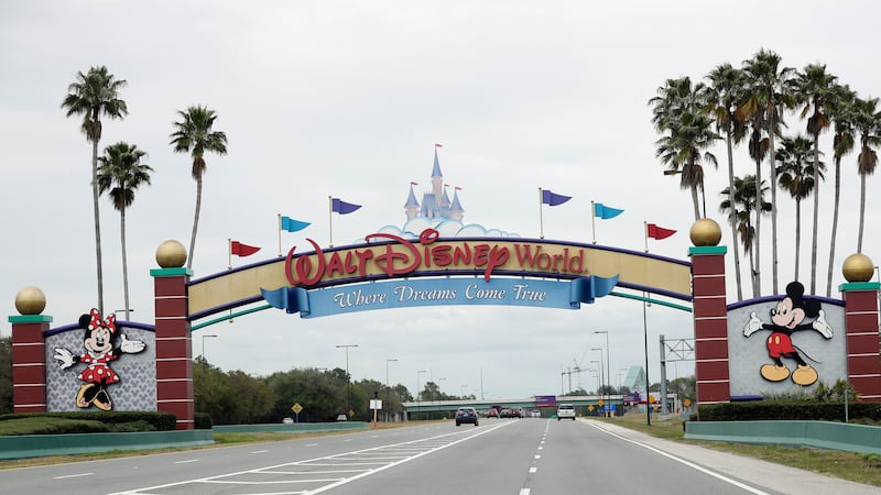 FILE - The road to the entrance of Walt Disney World, Monday, March 16, 2020, in Lake Buena...