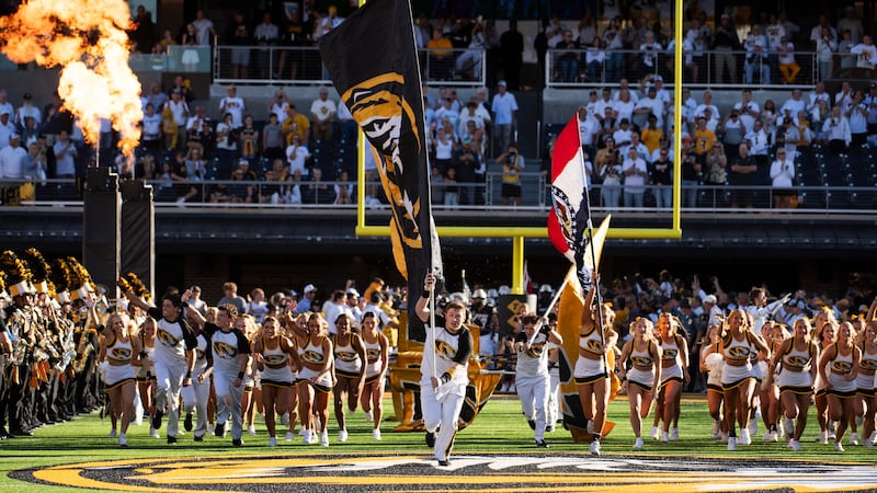 Missouri cheerleaders run on the field prior to an NCAA college football game against Buffalo...