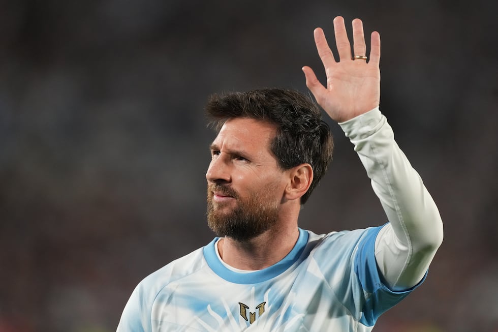 Argentina's Lionel Messi waves to fans before an international friendly soccer match against...