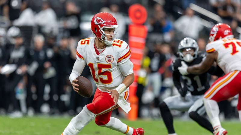 Kansas City Chiefs quarterback Patrick Mahomes (15) rolls out against the Las Vegas Raiders...